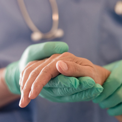 doctor holding patient hand