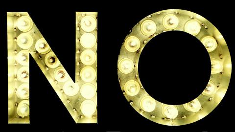 Image of the word No in gold neon lights