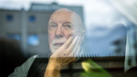 man looking out of a window