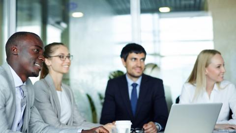 two women and two men in boardroom