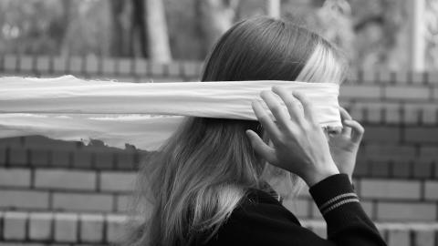 Woman with blindfold over her eyes