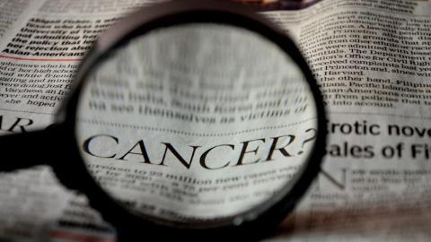 cancer research with magnifying glass