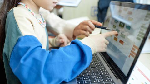 young child using laptop