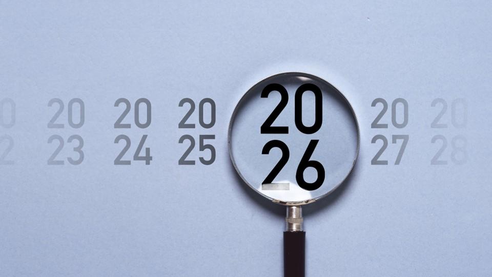 Magnifying glass over years including 2026