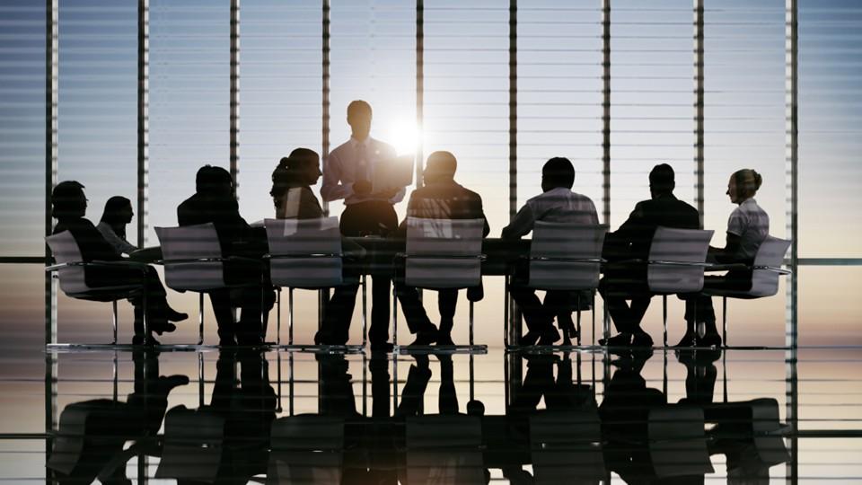 Board meeting, sunset behind speaker