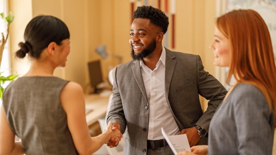 Man shakes woman's hand in signal of a business deal