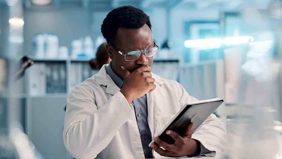 Clinician contemplating a tablet and protocols for CT design