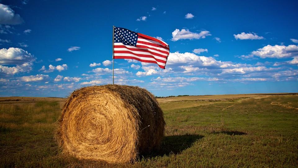 US flag in cylindrical hale bale