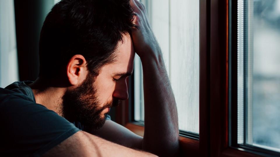 depressed man at the window