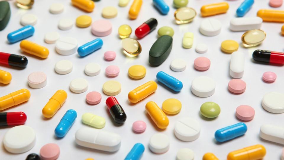 A variety of pills spilled onto a white surface