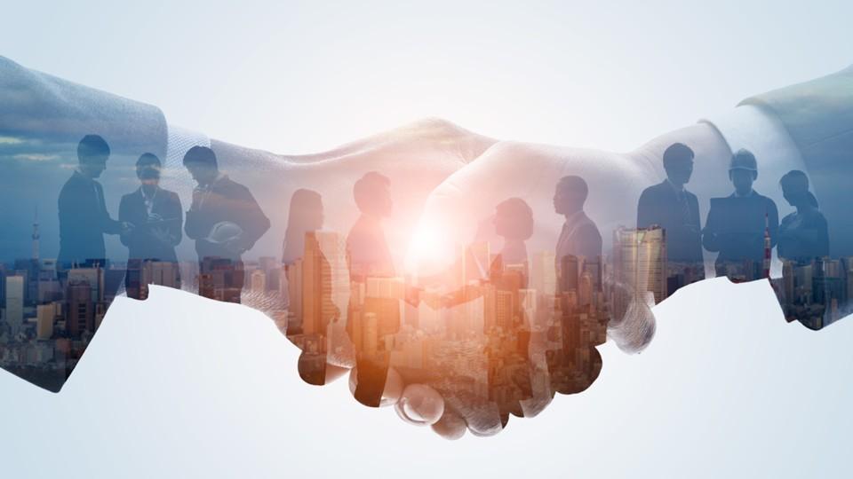 handshake and corporate body in the background of