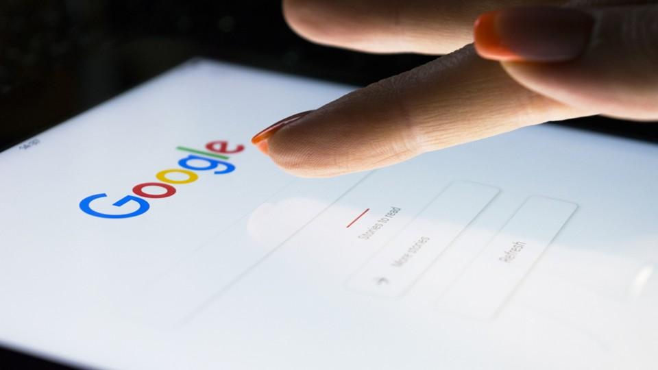 A woman uses a tablet for Google search