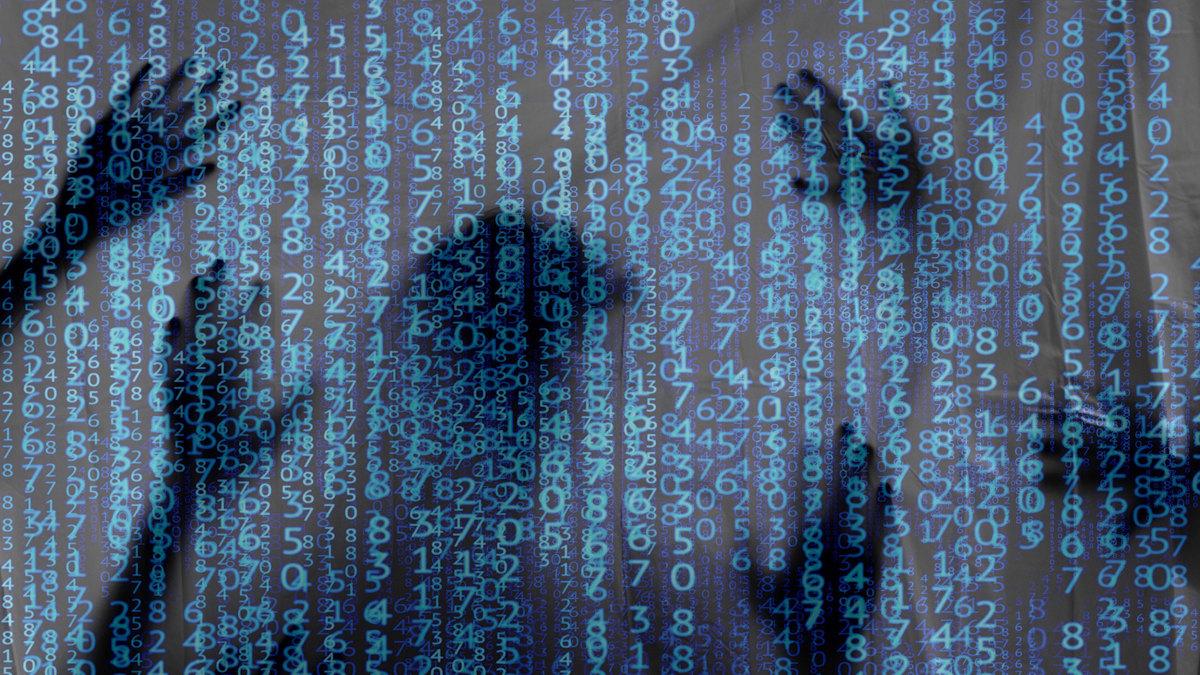 Silhouettes of people behind a dark screen of number sequences