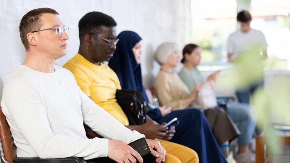 Diverse patients wait at modern clinic