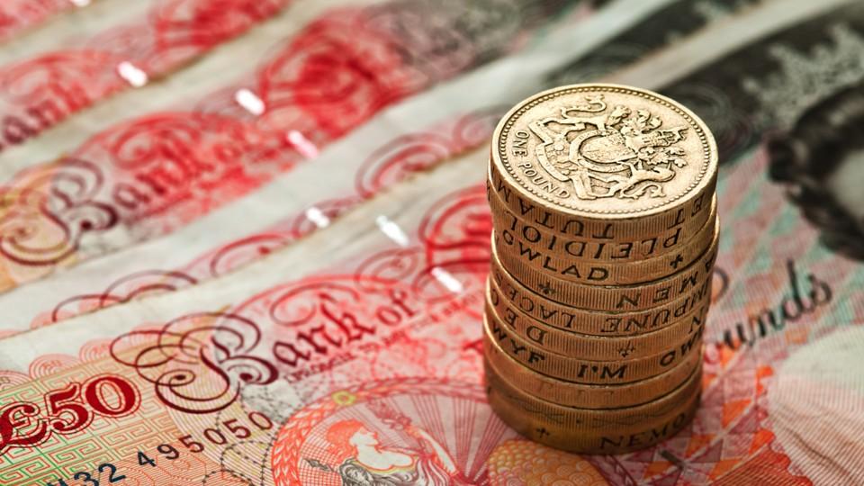 Pound coins on fifty pound notes