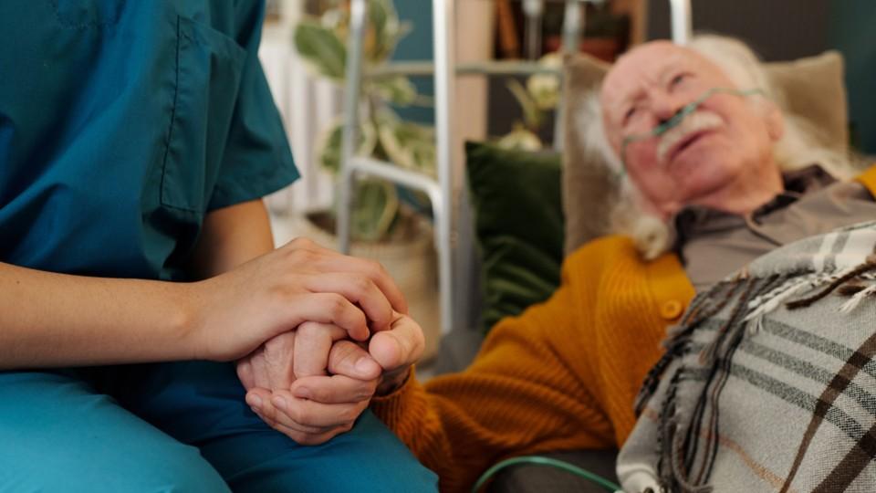 An elderly man receives at-home care