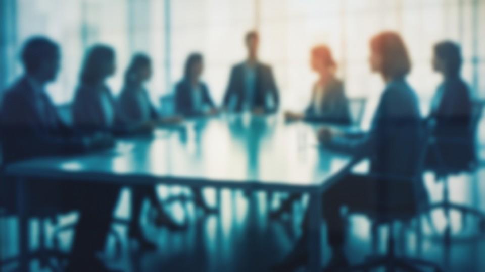 Board meeting, blurred colour image