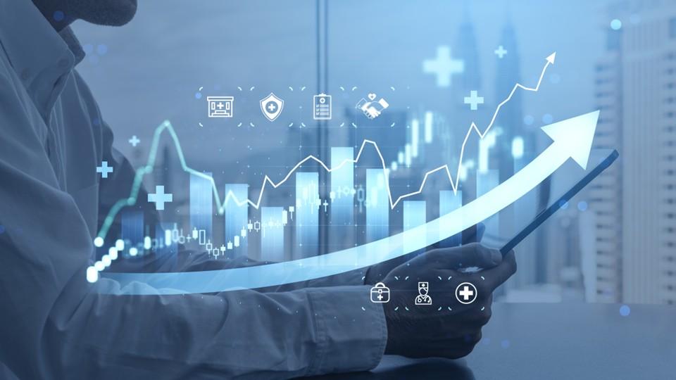 Bar chart with upward trajectory arrow overlain on businessman with healthcare symbols surrounding