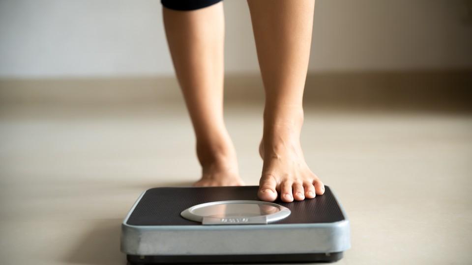 Female steps tentatively onto scales