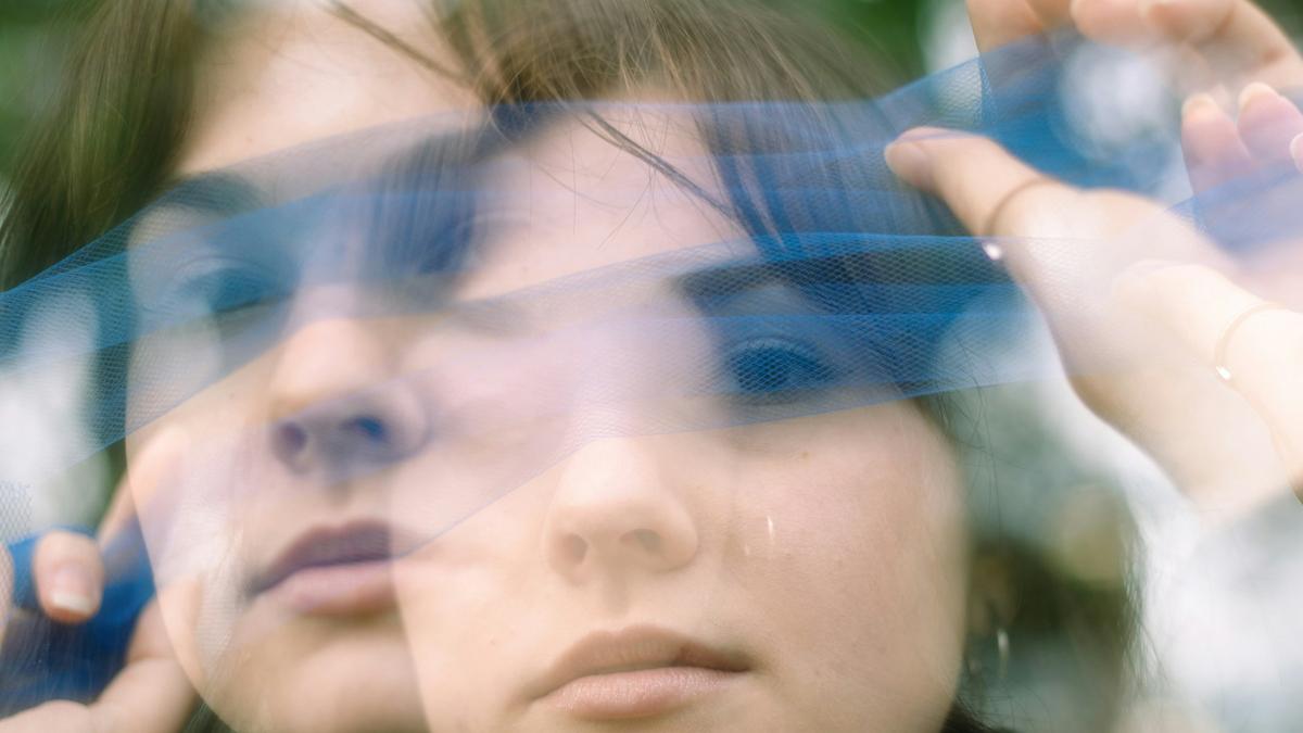 Broken image of a woman through eyes in double-vision