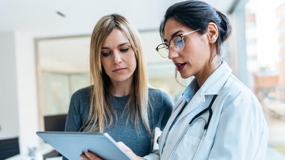 female HCP confers with female patient