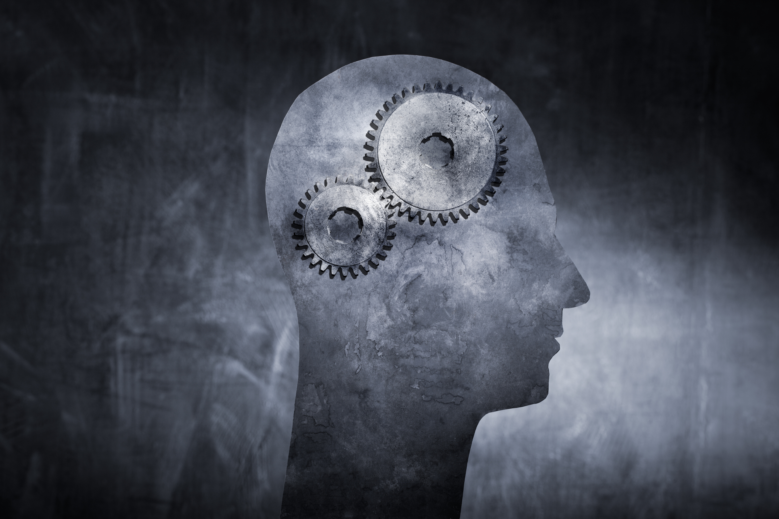 Conceptual image of a head with cog gears as brain.