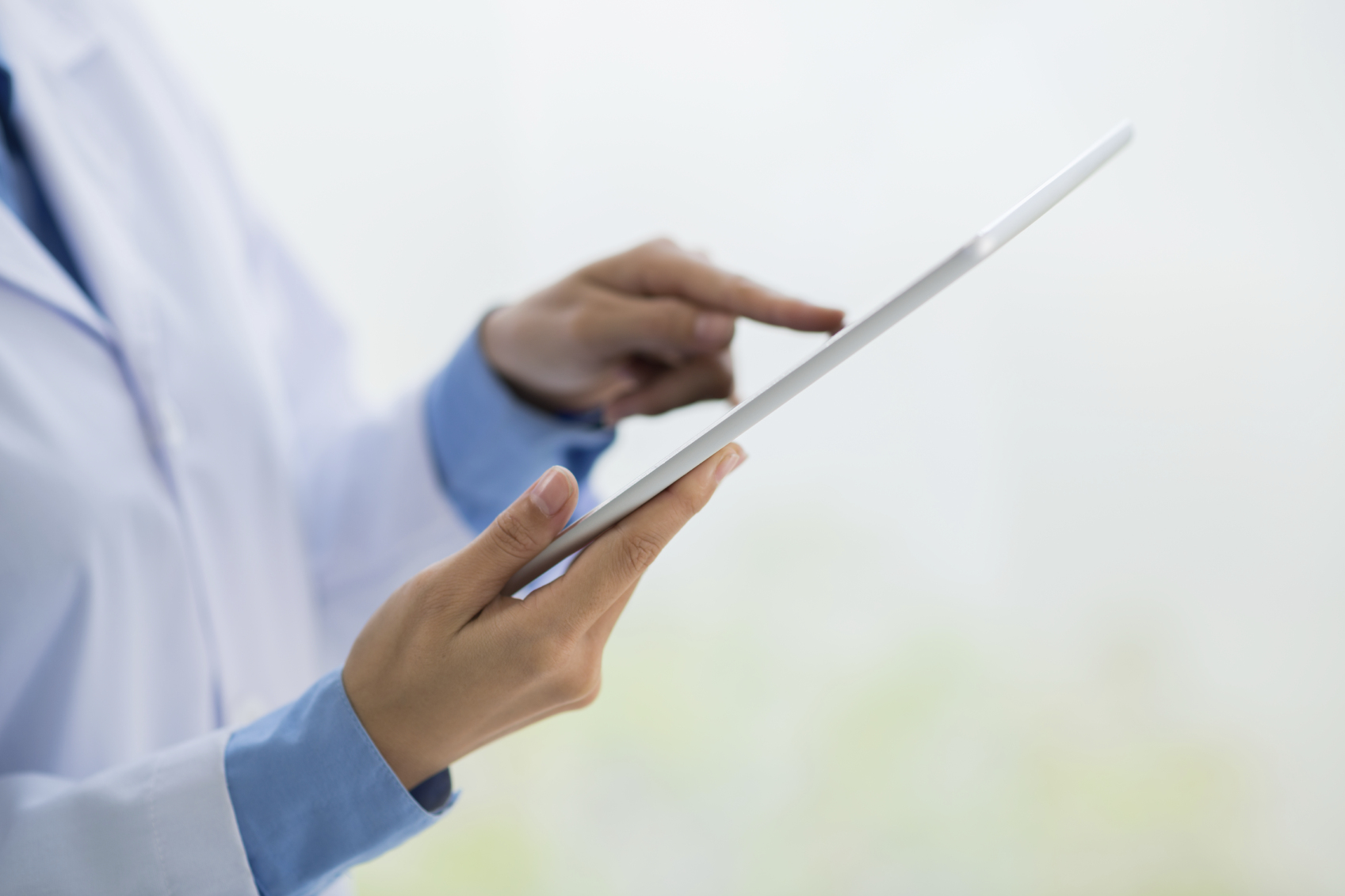 Hands of scientist working on digital tablet