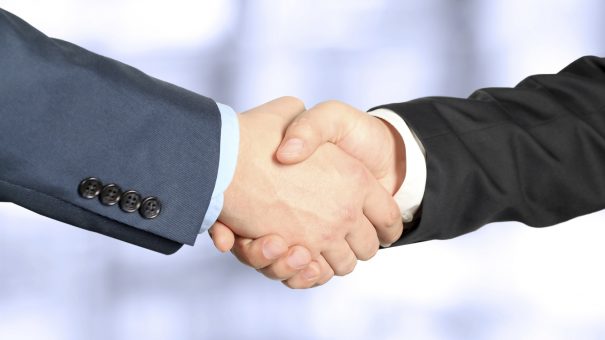 Close-up image of a firm handshake  between two colleagues