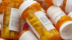 Several Prescription Pill Bottles in a Pile