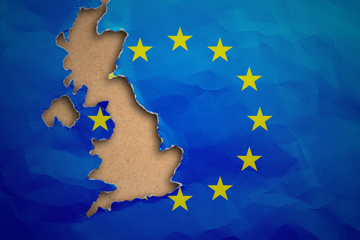 Piece in form of UK borders torn out from the flag of the European Union. United Kingdom withdrawal from the European Union. Brexit concept