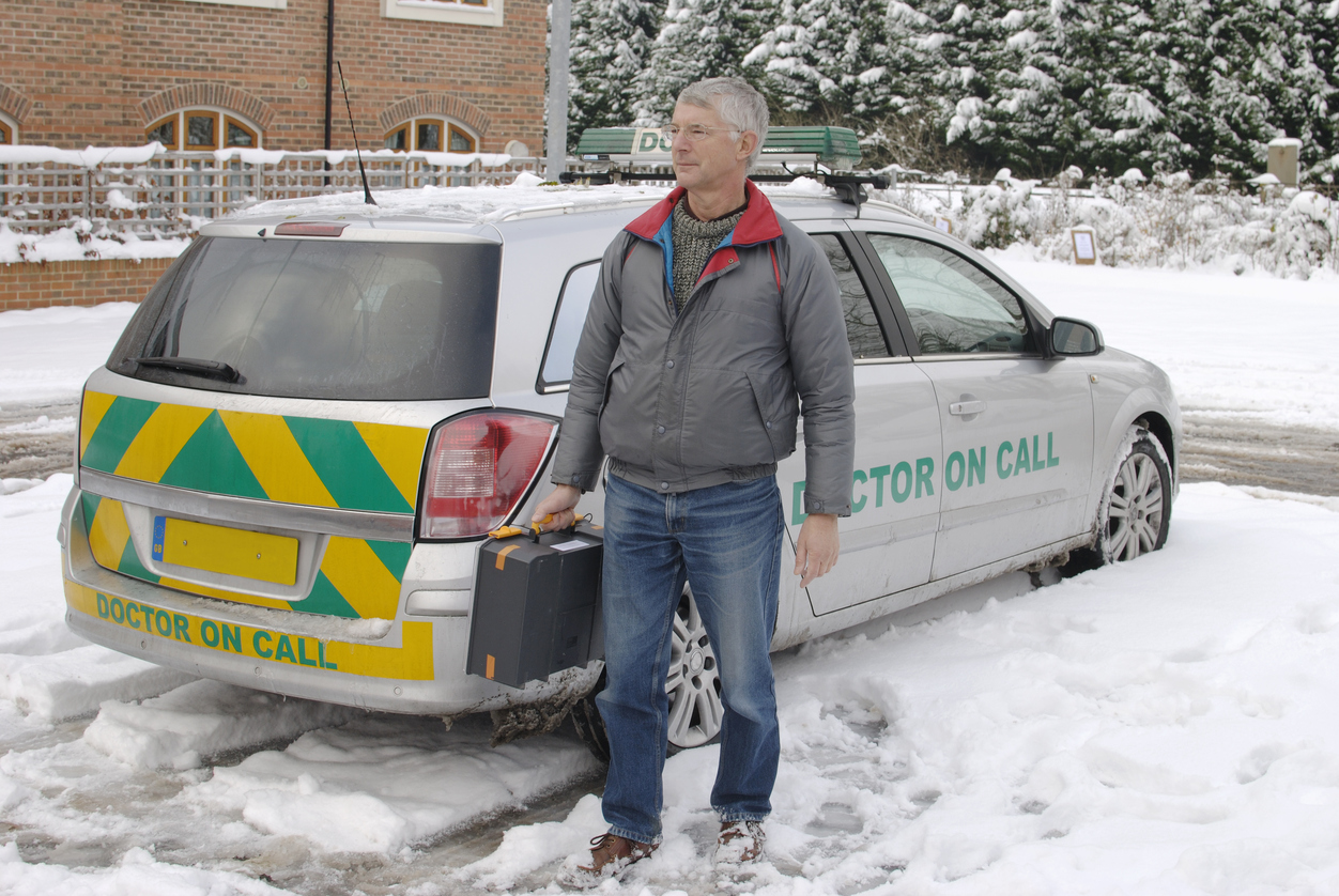 Doctor on call with drugs case leaving vehicle with snow on ground. England