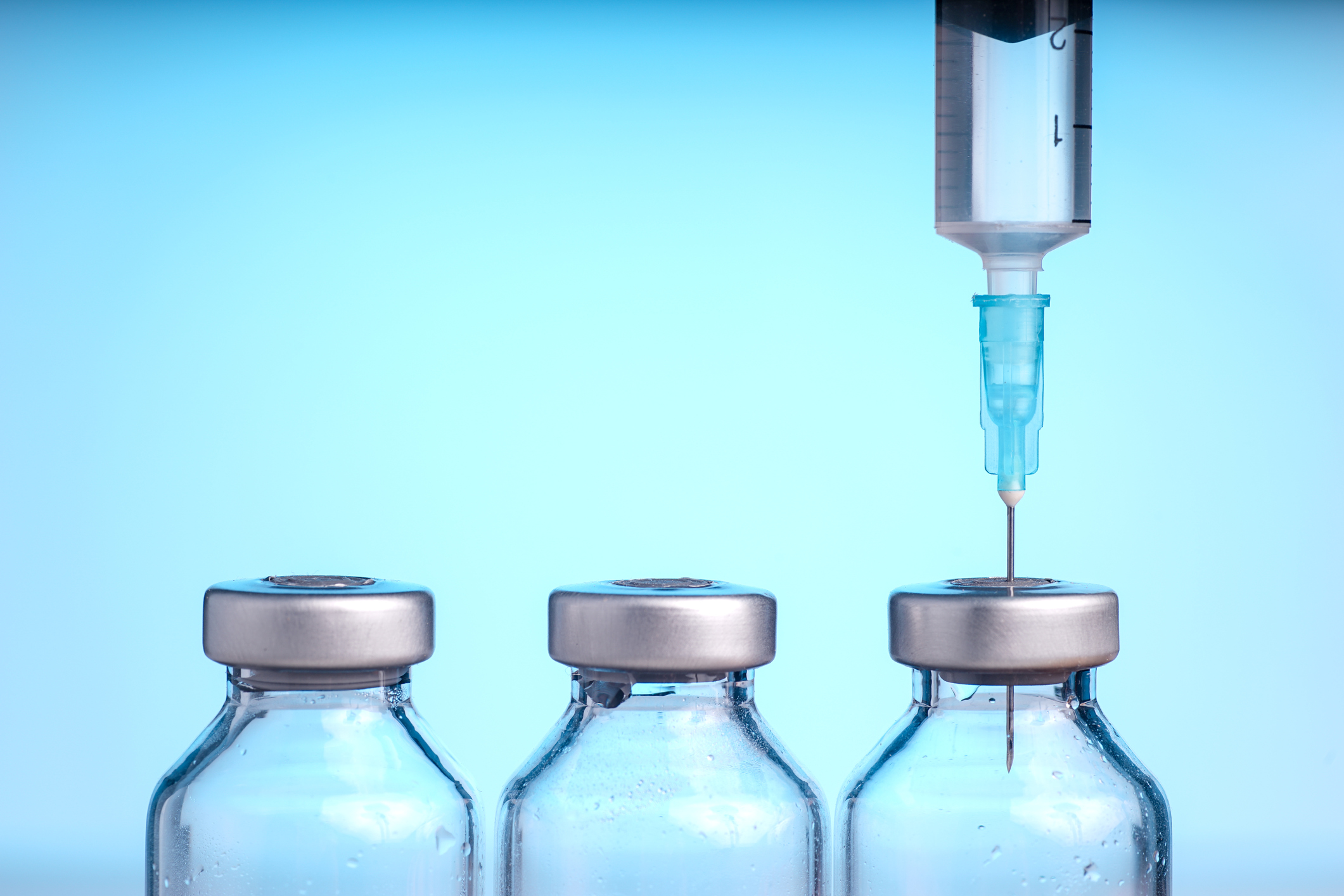 Medical vials and Syringe, Isolated on Blue background