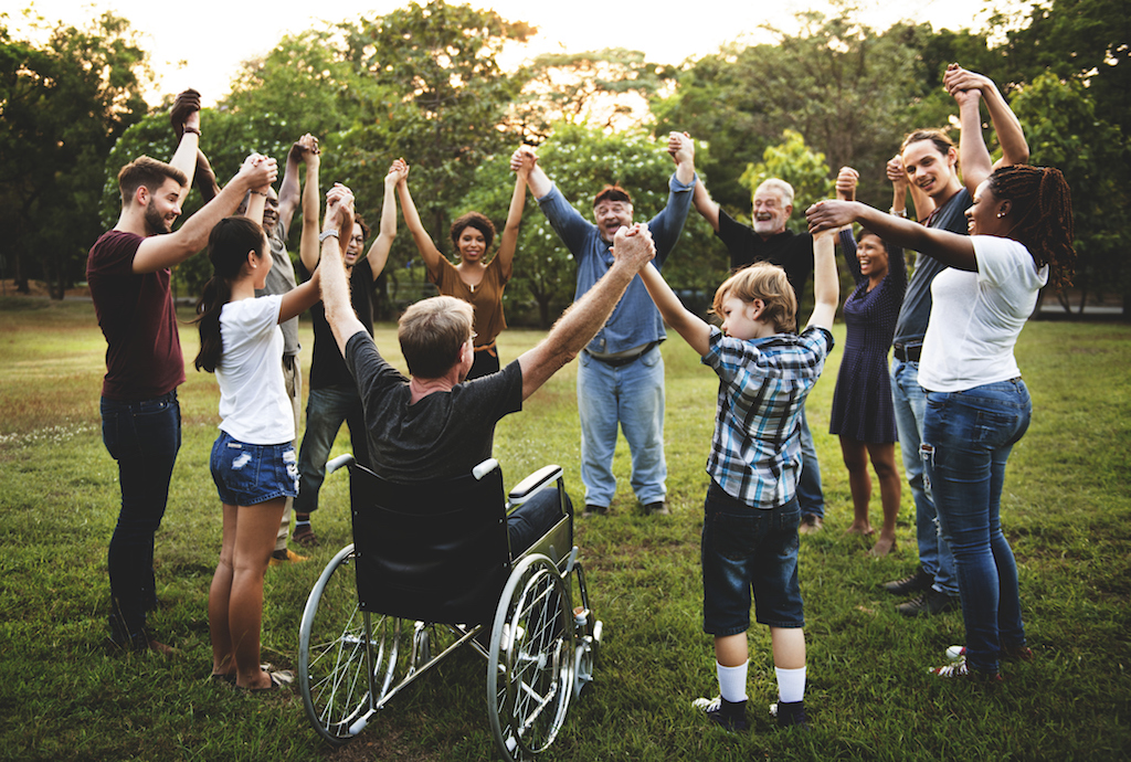 Group of people holding hand together in the park