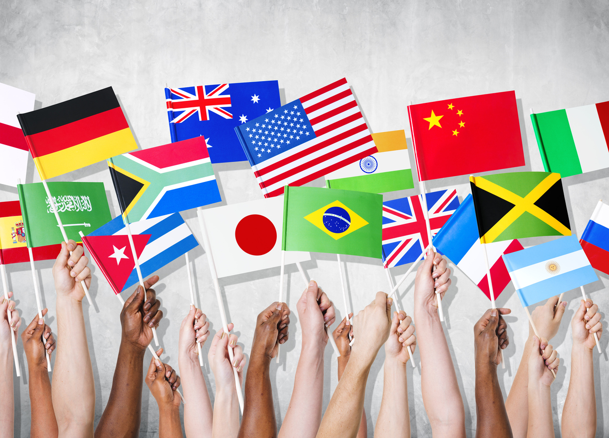 Group of hands holding national flags.