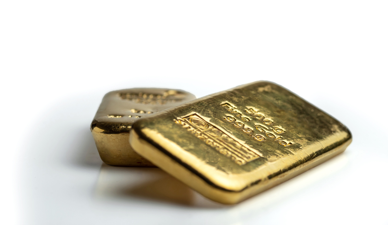 Two cast gold bars of different weights. isolated on a white background.