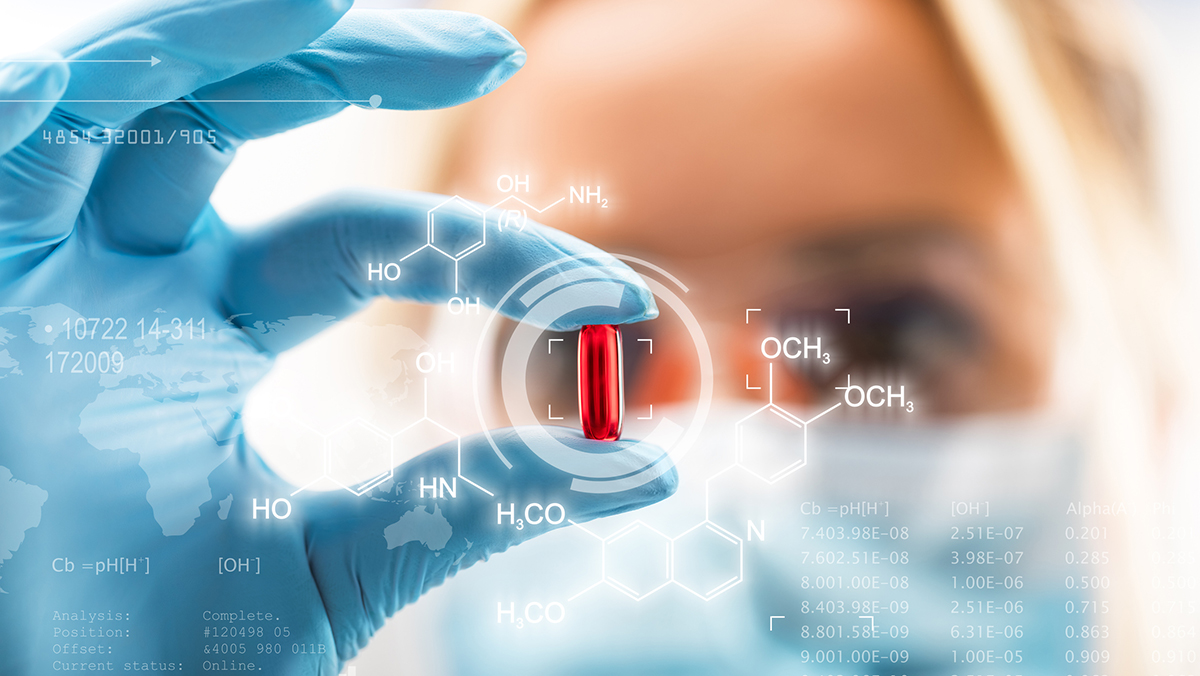 Young attractive female scientist holding a red transparent pill with futuristic scientific air interface with chemical formulas and research data in the foreground