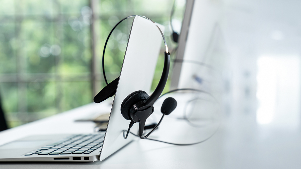 Headset and customer support equipment at call center ready for actively service . Corporate business help desk and telephone assistance concept .